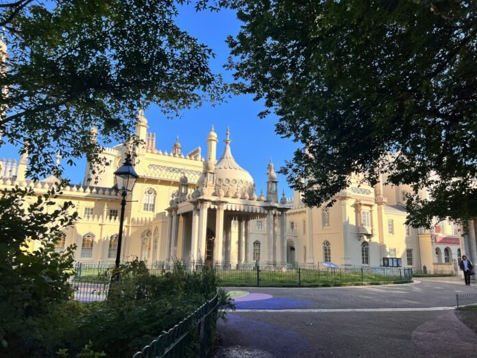 Ornate building with columns and domes under blue sky.