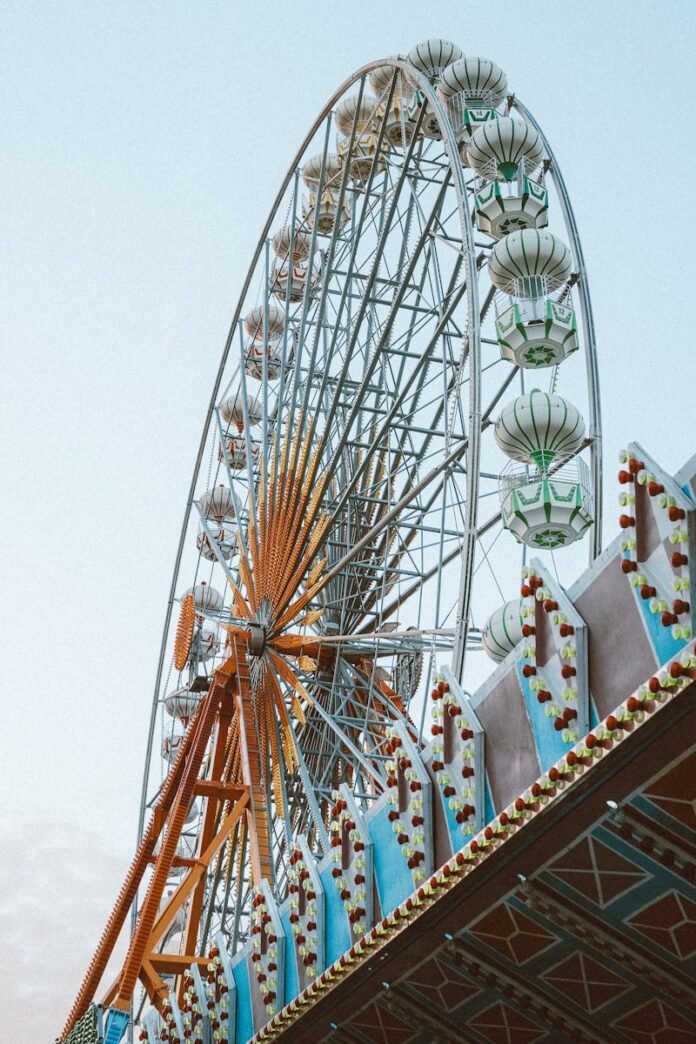a large ferris wheel sitting next to a tall building