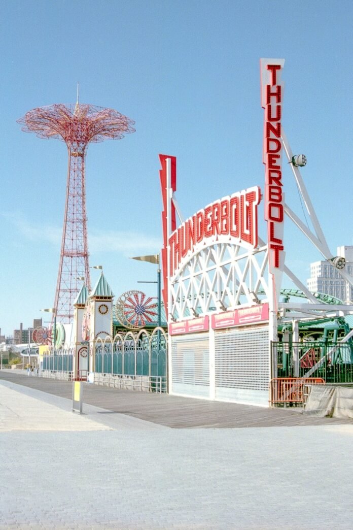 Amusement park rides under a clear blue sky